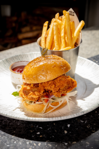 Fried Chili Chicken Burgers: Chicken thigh, green papaya slaw, peanut satay sauce, sesame seed brioche bun